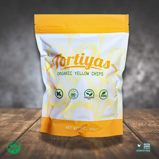 Product image of Tortiyas 6 ounce organic yellow tortilla chips on top of a wooden table