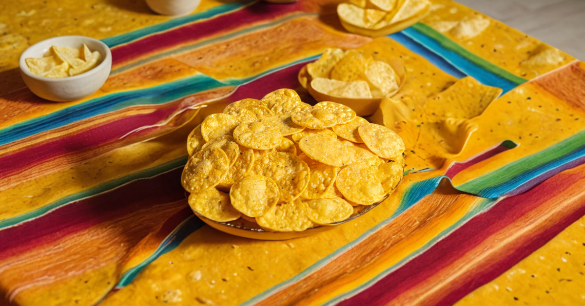 A plate of Tortiyas organic yellow corn chips on a colourful table setting